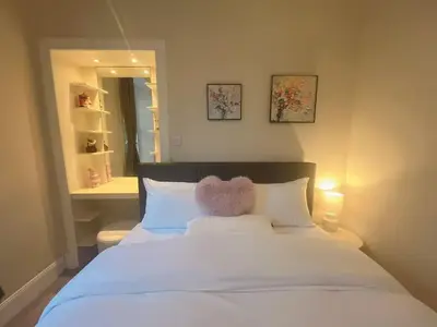 a bedroom with a white bed with a teddy bear on it at Adorable 2BR Apartment in Edinburgh