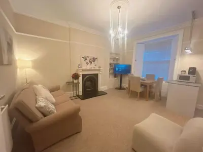 a living room with a couch and a table with a television at Adorable 2BR Apartment in Edinburgh