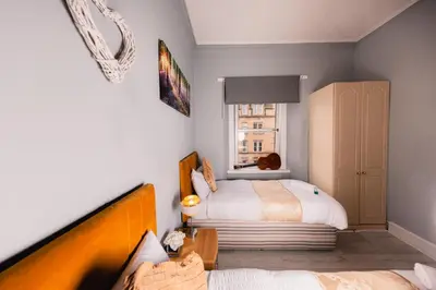 a bedroom with two beds and a window at Central Apartment by the Meadows 9 in Edinburgh