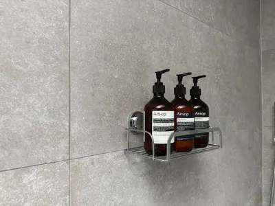 a rack with four bottles of alcohol on a wall at Burn Cottage - A Secluded Highland Retreat For Two in Fortingall