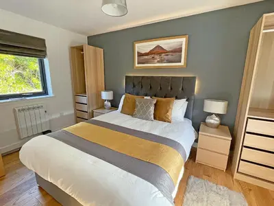a bedroom with a large bed and a window at Riverview Lodge in Acharra