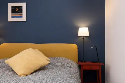 a bedroom with a bed with a pillow and a lamp at Chic 1-Bedroom Apartment in Edinburgh New Town in Edinburgh