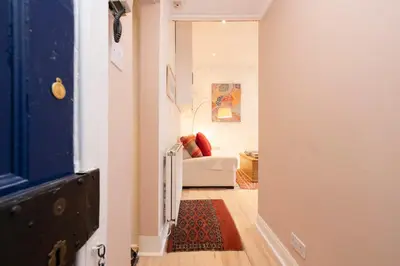 a view of a hallway with a couch in a room at Chic 1-Bedroom Apartment in Edinburgh New Town in Edinburgh