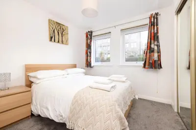 a bedroom with a bed and a window at Edinburgh Morningside 2-Bedroom Apartment - Ground Floor in Edinburgh