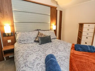 a bedroom with a bed with two pillows on it at Loch Lomond Holiday home in Arrochar