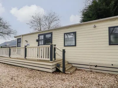 a mobile home with a porch and a deck at Loch Lomond Holiday home in Arrochar