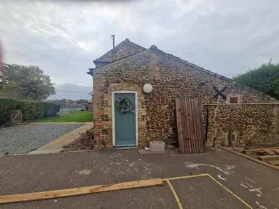 a small stone building with a blue door at The Old school House in Moffat