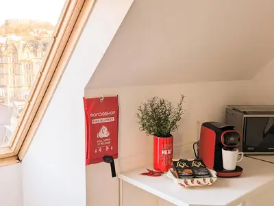 a small kitchen with a window and a microwave at Littlebay Penthouse in Oban