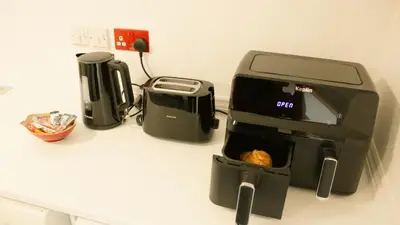 a toaster sitting on a counter next to a coffee maker at Littlebay Penthouse in Oban