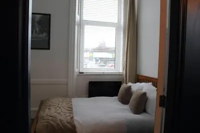 a bedroom with a bed in front of a window at 89A Bank Street 3 bedroom in Jamestown