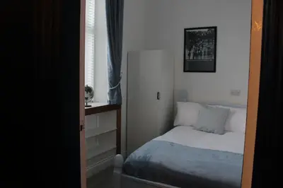 a small bedroom with a bed and a window at 89A Bank Street 3 bedroom in Jamestown