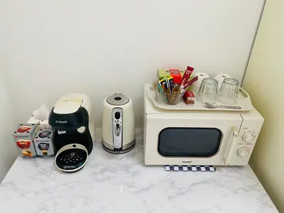 a counter with a microwave and other appliances on it at Cozy Room in Glasgow in Glasgow