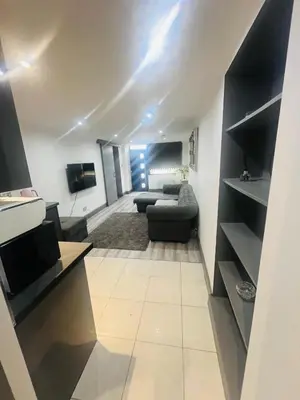 a living room with a couch and a tv at 96 Glasgow road in Newbridge