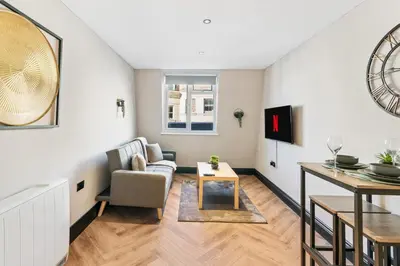 a living room with a couch and a table at Newly Renovated 1BR Steps from Hove Beach in Moffat