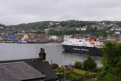 a large boat in a river in a city at Inveree in Oban