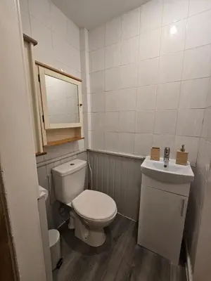 a small bathroom with a toilet and a sink at Comfy Semi-Central Stay near Entertainment Park in Edinburgh