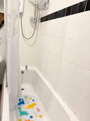 a bathroom with a bath tub with a toy in it at Happy home stay in Cowlairs