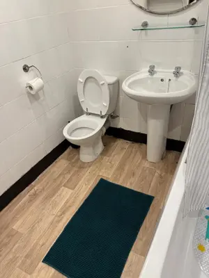 a bathroom with a toilet and a sink at Happy home stay in Cowlairs