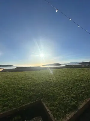 a field with the sun in the sky at The Skipper's Rest in Millport