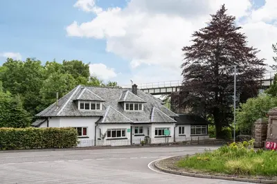 a white house on the side of a road at Glenbruar House in Crianlarich