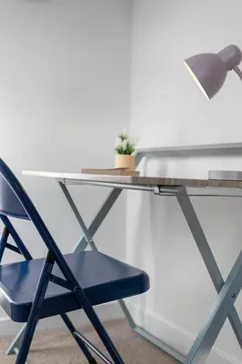 a desk with a blue chair and a lamp at Fraser Apartment- 2 Bedrooms Inverleith, Edinburgh in Edinburgh