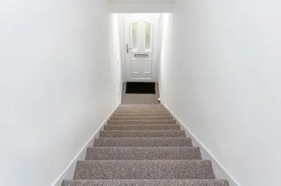 a stairway leading up to a white door at Fraser Apartment- 2 Bedrooms Inverleith, Edinburgh in Edinburgh