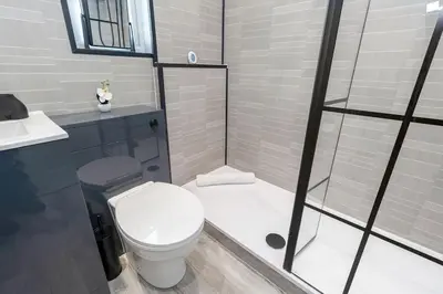 a bathroom with a white toilet and a shower at Fraser Apartment- 2 Bedrooms Inverleith, Edinburgh in Edinburgh