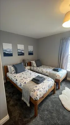 a room with two beds in a room at Bay View Apartment in Oban