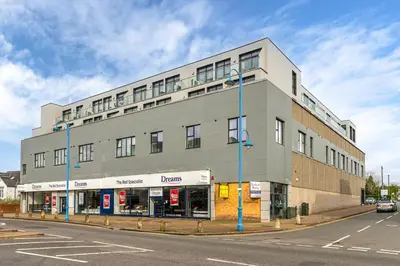 a large building on the corner of a street at Modern 2-Bed Flat with Balcony and Free Parking - Ideal for Contractors in Moffat