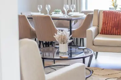 a dining room with chairs and a table with a vase at Pinkerton House - 3 bed Rutherglen in Glasgow