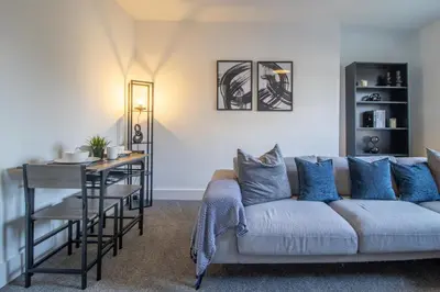 a living room with a couch and a table at The Wishy - 2 Bedroom Flat in Newmains in Newmains