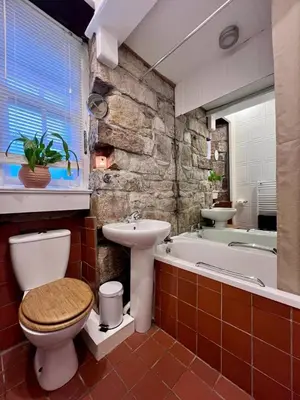 a bathroom with a toilet and a sink and a tub at Edinburgh, DeanVillage Cosy Hideaway Apartment in Edinburgh