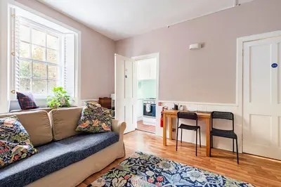 a living room with a couch and a table at Edinburgh, DeanVillage Cosy Hideaway Apartment in Edinburgh