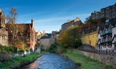 a river in the middle of a city with buildings at Edinburgh, DeanVillage Cosy Hideaway Apartment in Edinburgh