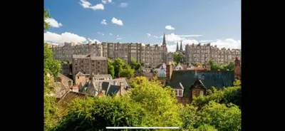 a view of a city with tall buildings and trees at Edinburgh, DeanVillage Cosy Hideaway Apartment in Edinburgh