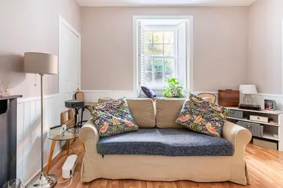 a living room with a couch and a window at Edinburgh, DeanVillage Cosy Hideaway Apartment in Edinburgh
