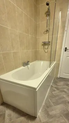 a white bath tub in a bathroom with a shower at Stirling apartment - free parking in Stirling