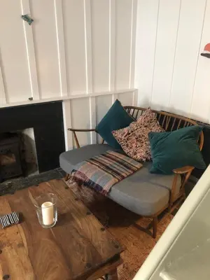 a couch with pillows on it in a living room at Romantic Cottage, Port Isaac in Moffat