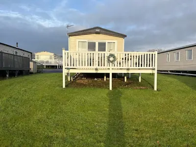 a house with a porch with a wreath on it at Home from Home at the Hendersons Caravan in Kilwinning