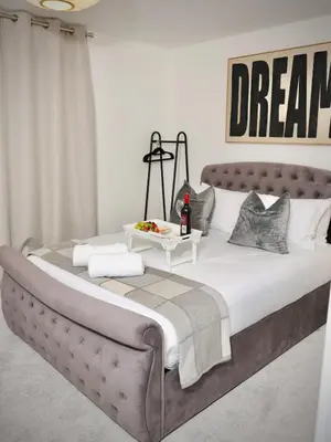 a bedroom with a large bed with a table on it at Premium 4BR I Near Golf Course I Fast Wi-Fi & Free Parking in Moffat