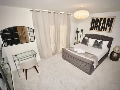 a bedroom with a bed and a chair and a table at Premium 4BR I Near Golf Course I Fast Wi-Fi & Free Parking in Moffat