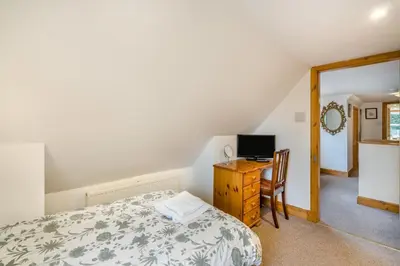 a bedroom with a bed and a desk with a television at 3 Bed in New Galloway oc-r34387 in New Galloway