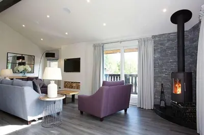 a living room with a couch and a fireplace at Ardeonaig Rock in Morenish
