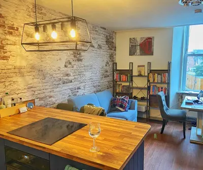 a living room with a wine glass on a table at Two-bedroom city retreat close to top sites in Edinburgh