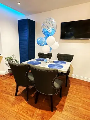 a dining room with a table with blue and white balloons at Two-bedroom city retreat close to top sites in Edinburgh