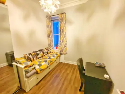 a living room with a couch and a table at Two-bedroom city retreat close to top sites in Edinburgh