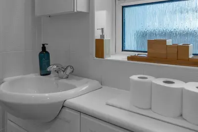 a bathroom with a sink and two rolls of toilet paper at Executive 3 Bedroom - Corporate And Contractor Stays in Glasgow