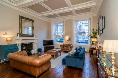 a living room filled with furniture and a fireplace at Georgian Elegance with Patio Garden West End - Pass the Keys in Edinburgh