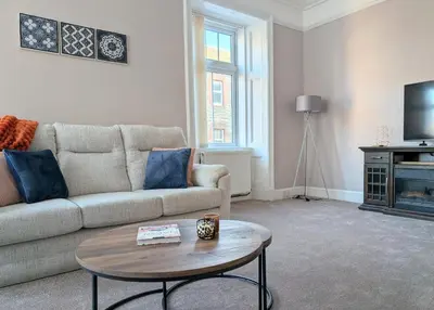 a living room with a couch and a coffee table at Longrow Apartment in Campbeltown