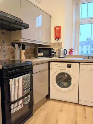 a kitchen with a stove and a dishwasher at Longrow Apartment in Campbeltown